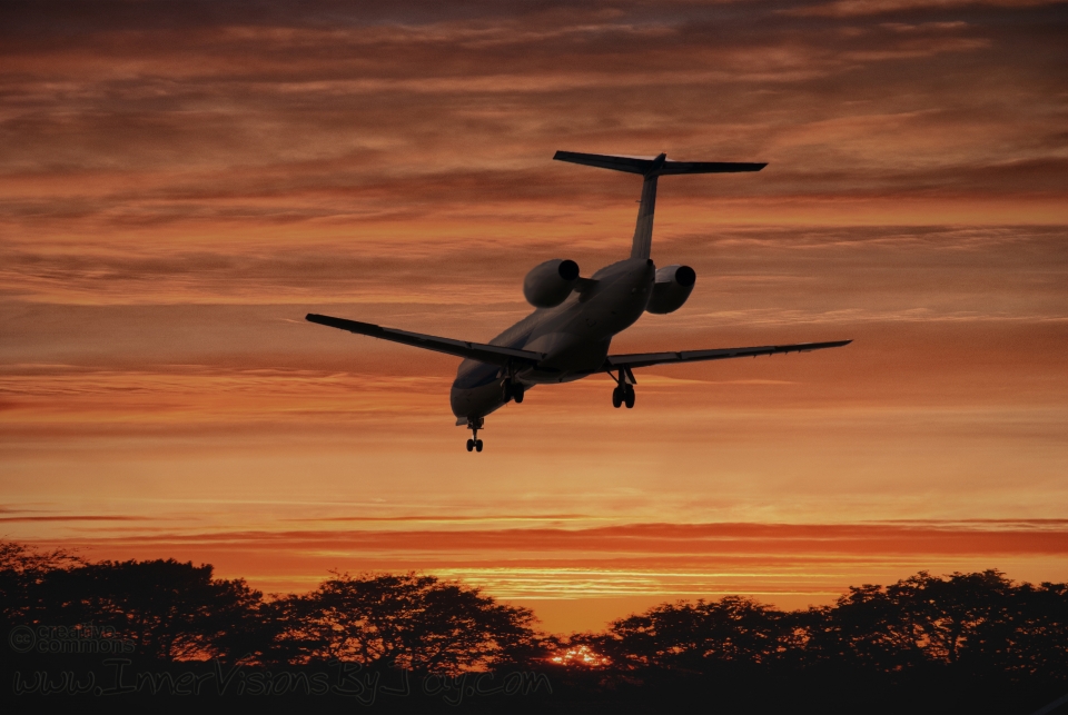 Afterburn Airplane's descent against fiery sunset
