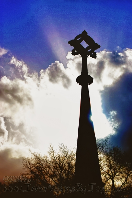 Silhouette of Celtic Cross Grave Marker against the sunrise
