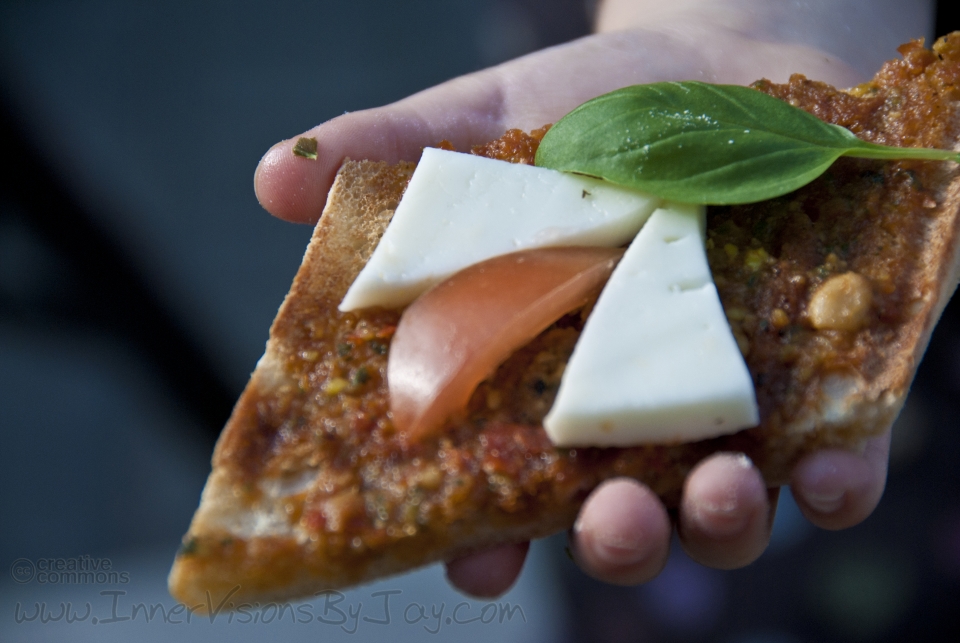 Gradient focus of child's hand hiolding bruschetta