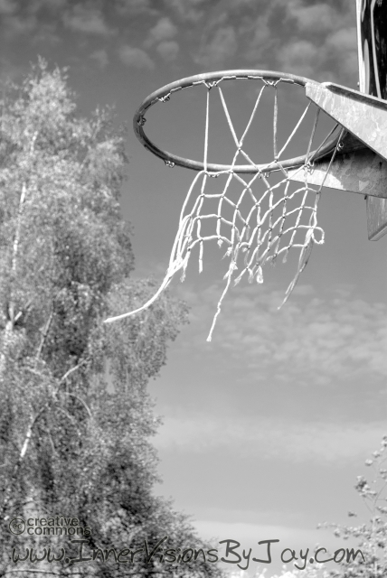 Tattered basketball net in black and white post-apocalyptic image