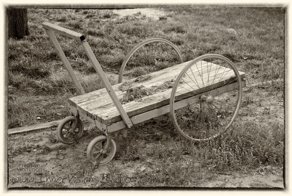 Grandad's Burden Abandoned antique pushcart in sepia