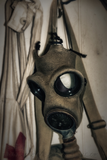 Medic Gas maks hanging on hook by Red Cross apron