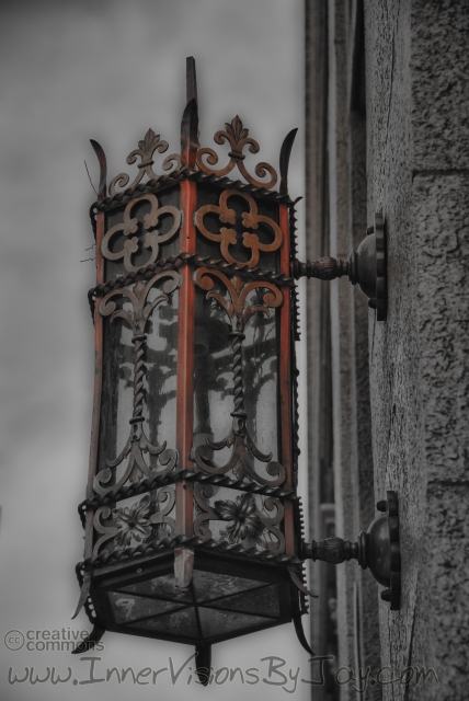 Sir Doyle's Bleed Black and white old-fashioned street lamp with red oozing from the top